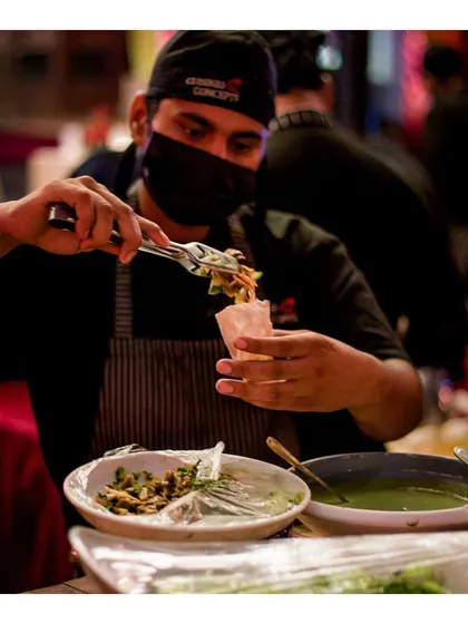 A chef prepares Goan poee pockets, stuffing them with a flavourful filling. This highlights our innovative approach to regional Indian cuisine, presenting it in a modern, easy to eat format.