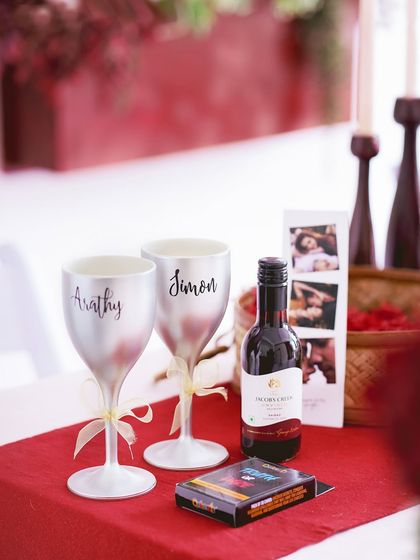The personalized wine glasses and bottle from the hamper, set up for a toast.