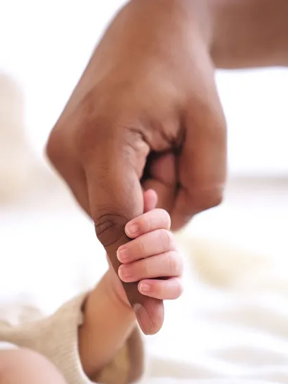 The tiniest details are often the most precious. This close-up of a newborn's hand holding their parent's finger is a powerful reminder of how small they once were.