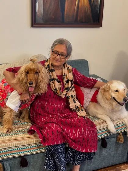 Dida (grandma) with her two grand-dogs, Posto and Paro, during the Durga Puja celebrations.