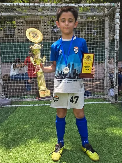 One of our U-9 stars, Reyansh Damania, with his trophy and Player of the Match award.