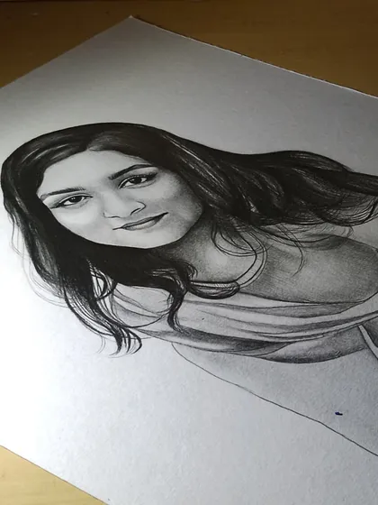 A close-up of the same portrait in progress. Capturing a likeness is a careful process of observation and shading.