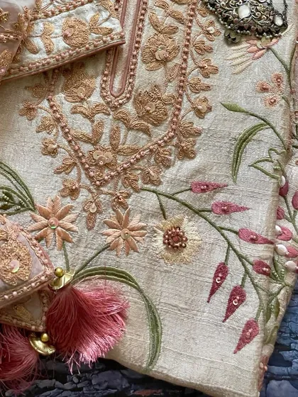A flat-lay of the suit, showing the beautiful combination of embroidery and embellishments.