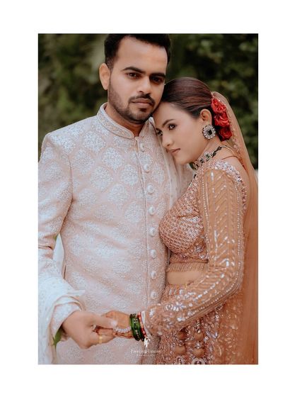 A close-up portrait of the couple in a tender embrace, showcasing their traditional wedding attire and the emotion of the day.