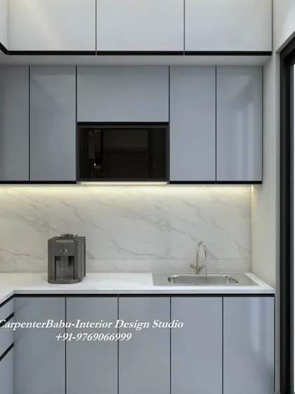 This kitchen uses a light grey laminate for the cabinets, creating a soft and contemporary feel. The open layout connects it to the rest of the living space.