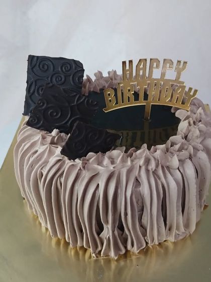 A heart-shaped chocolate cake with beautiful piped frosting.