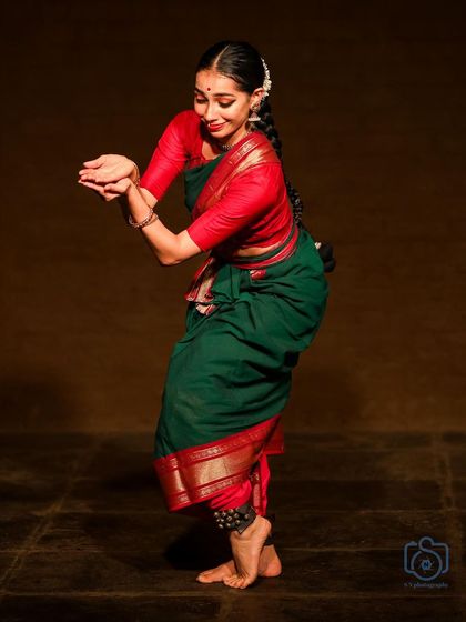 A gentle and devotional pose from a performance. This showcases the softer, more lyrical side of Bharatanatyam storytelling.