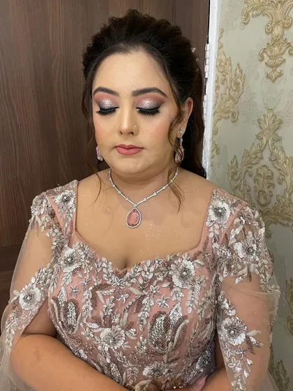 A close-up of the party makeup, with shimmery eyeshadow and a perfectly matched pink lip.