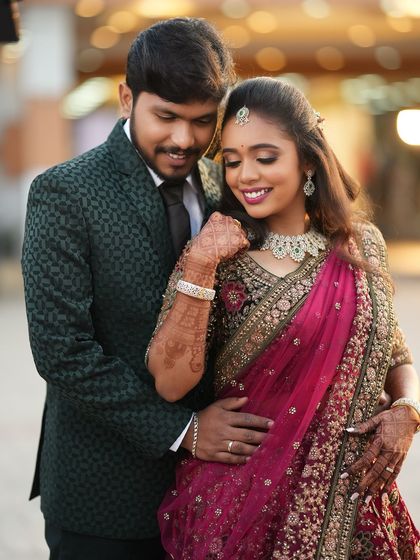 A romantic moment between Dr. Saruna and her groom. Her makeup looks flawless even in the golden hour light, creating a soft and dreamy effect.