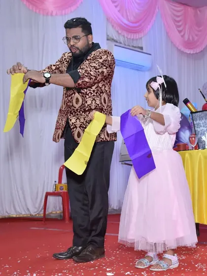 A young birthday girl helps me with a colorful silk trick. Making the birthday child the center of attention is my specialty.