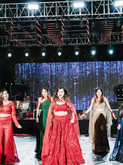 The bride and her bridesmaids take center stage for a choreographed performance. I ensure the stage design, lighting, and sound are perfectly synced to make their performance a highlight of the Sangeet night.