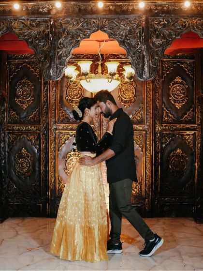 A romantic dance in front of the ornate, warmly lit doorway.