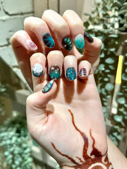 An enchanting underwater-themed set with deep teal colors and delicate, hand-painted details that look like sea life.