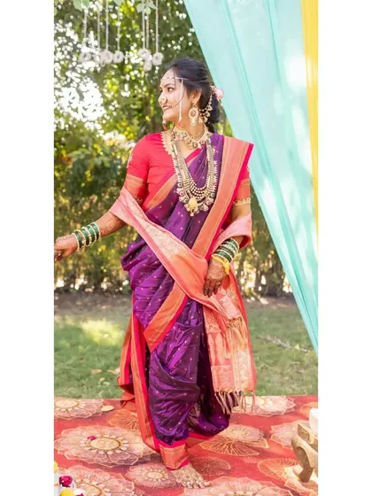 A full-length view of this stunning bride in her Nauvari saree. The makeup is balanced to complement the rich colors and traditional draping of her outfit.
