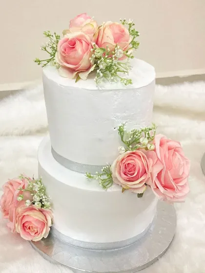 Here is another cake from the same last-minute wedding order. This two-tier design is clean and classic, with simple white frosting and elegant pink silk roses, proving that beauty doesn't always require long lead times.