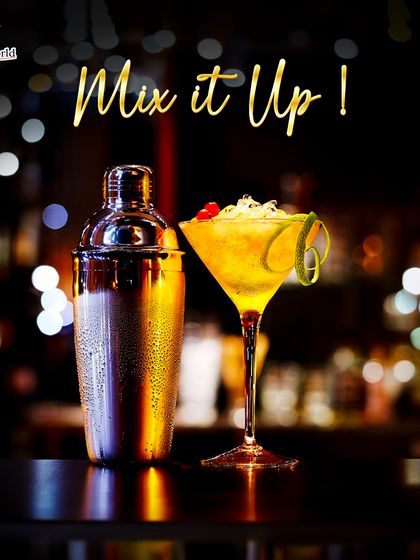 Time to mix it up. A classic shaker next to a perfectly chilled martini-style cocktail, ready to be enjoyed. This image captures the essence of cocktail hour.