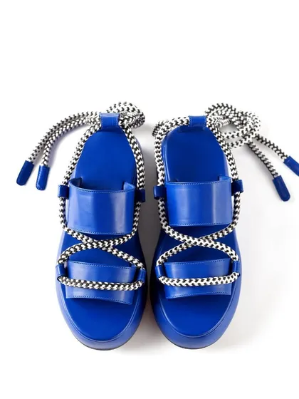 A top-down view of the vibrant blue platform sandals, showcasing their symmetrical design and striking color.