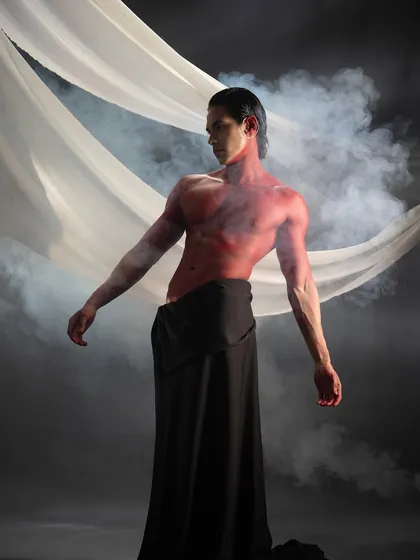 A powerful, contorted pose that highlights the artistic and performance aspect of this body paint project.