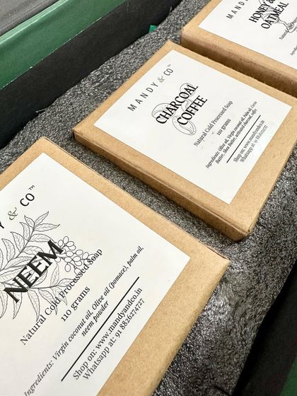 A shot of my packaged artisanal soaps, including Neem, Charcoal Coffee, and Honey & Oatmeal, ready to be shipped to customers.