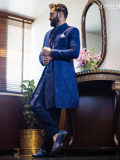 The client strikes a pose, showing off the full silhouette of his modern navy blue Indo-Western outfit. The clean lines and deep color make it a sophisticated choice for an evening event.