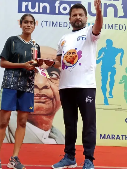 Receiving the trophy for a 2nd place finish in the 5km Run for Unity road race.