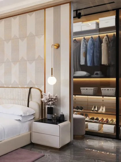 This bedroom features a unique geometric-patterned wall, a stylish bedside pendant light, and a seamlessly integrated walk-in closet with glass doors.