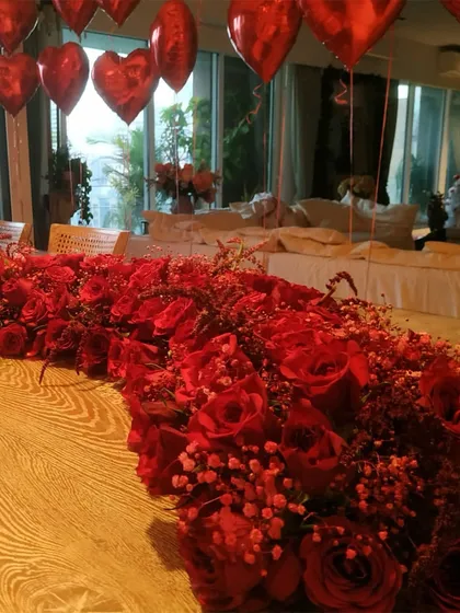 A detailed shot of the magnificent red rose and baby's breath table runner, perfect for a romantic celebration.
