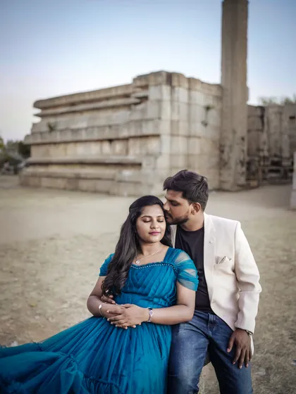 The flowing blue gown looks stunning against the ancient stone. A perfect blend of modern style and timeless history for a pre-wedding shoot.