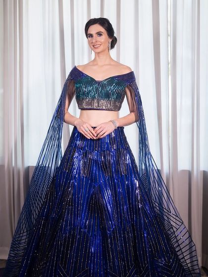 A smiling portrait of our model, looking chic and sophisticated. This is the perfect inspiration for a high-fashion engagement look.