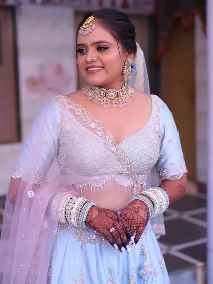 This bride chose a lovely pastel blue lehenga, so we created a soft and dewy makeup look with a pinkish nude lip to match the delicate color palette.