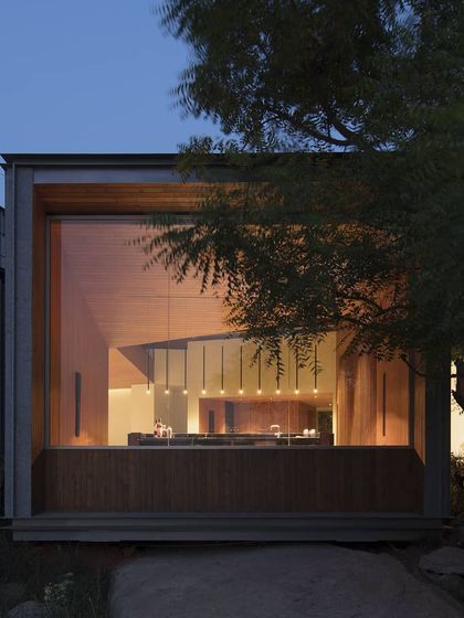 The lighting design for this lake house in Hyderabad was crucial. Here, a series of pendants creates a warm, glowing portal, making the interior feel connected to the landscape even at night.