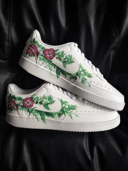 A pair shot of the pink floral custom Nike Court Visions.