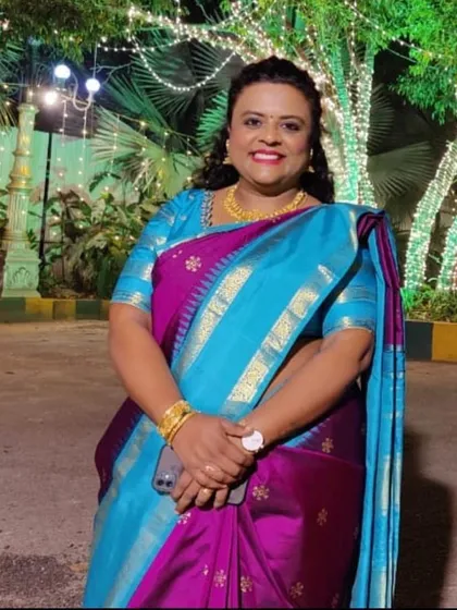Look at that radiant smile. This is the beautiful result of our revamp service, where we took a plain Kanjeevaram and gave it a new life with intricate block prints, making it perfect for a grand celebration.