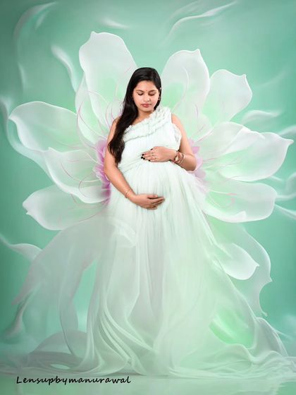 A truly ethereal portrait where I have blended a photo of the mother in a flowing white gown with an artistic floral background. This editing style creates a dreamy, magical image that celebrates the bloom of motherhood.