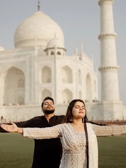 A fun and iconic pose with arms outstretched, celebrating your love in front of the world's most famous monument to it. It's a joyful and expressive shot.