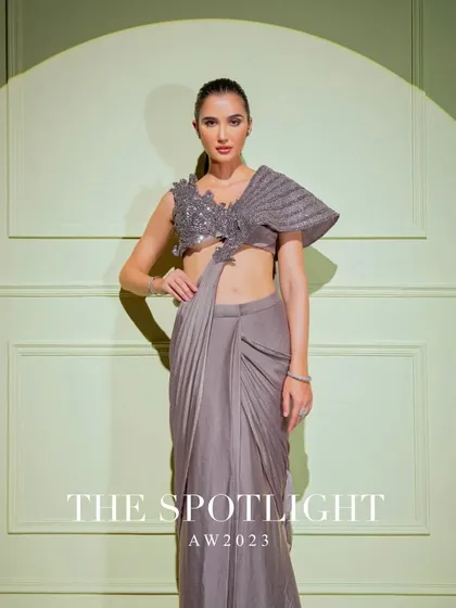 A full shot of the grey drape saree with its statement one-shoulder pleated blouse, a true piece of wearable art.
