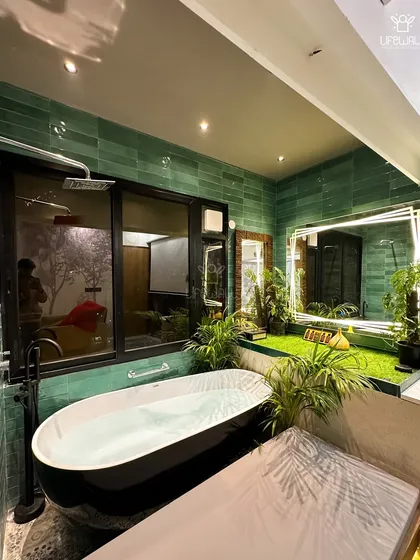 Who said your bathroom can't feel like a spa? We built this porta cabin with a freestanding bathtub, an indoor green turf area, and large windows looking out onto the terrace garden, creating a seamless connection with nature.