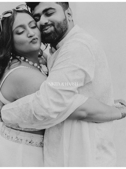 An embrace that is both playful and loving. This black and white portrait of Nikita and Harsh, with their names overlaid, feels like a personal, intimate memory captured forever.