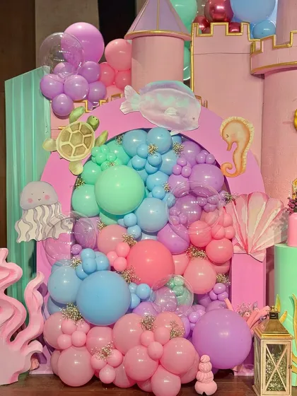 From a pastel soft play area and a cotton candy cart to a buffet with an LED screen backdrop showing aquatic life, every element was designed to immerse guests in Miraya's mermaid world.