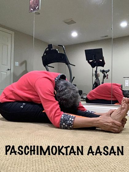 A deep seated forward bend, showing how I use my hands to gently guide the stretch. This is a key asana for hamstring flexibility and calming the mind.