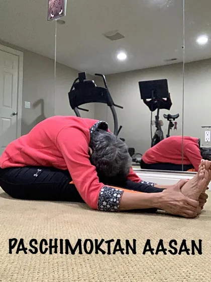A deep seated forward bend, showing how I use my hands to gently guide the stretch. This is a key asana for hamstring flexibility and calming the mind.