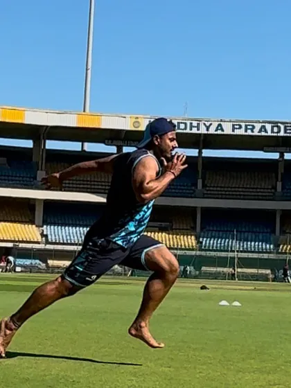 Mid-stride during a barefoot sprint. The focus is on generating maximum force with each step to improve speed and power.