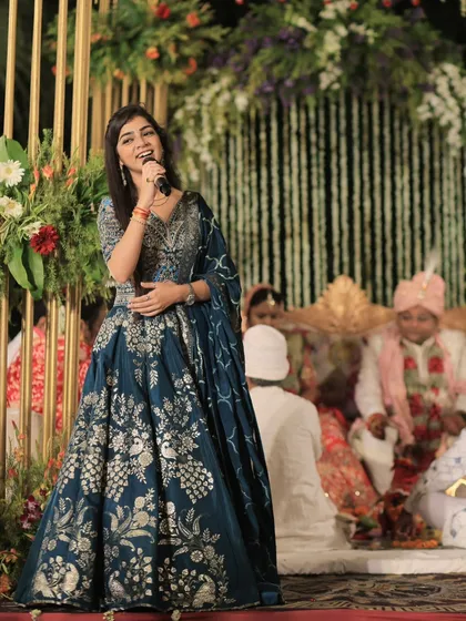 Performing on a beautifully decorated stage, with the bride and groom in the background. My goal is always to create a magical soundtrack for their special moments.