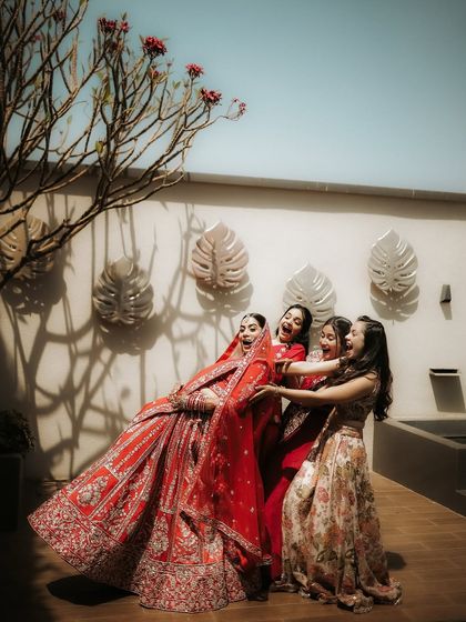 A fun and candid moment with the bridesmaids. The bride and her squad share a laugh, a beautiful memory of friendship and support on the big day.