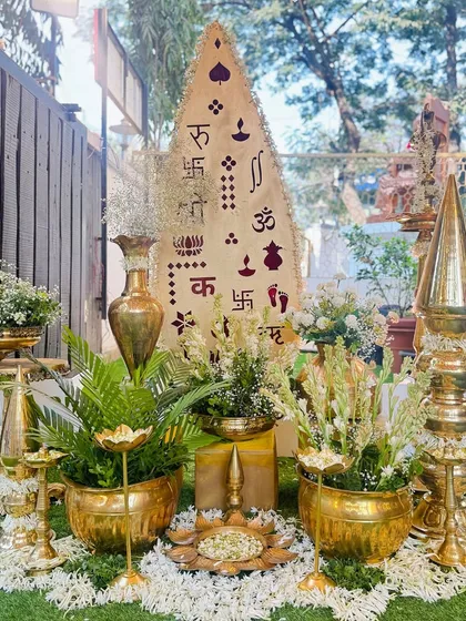 We believe details make the difference. This setup for a pre-wedding ceremony features polished brass props, including vases and diyas, filled with fragrant mogra and rajnigandha flowers, creating an elegant and auspicious focal point.