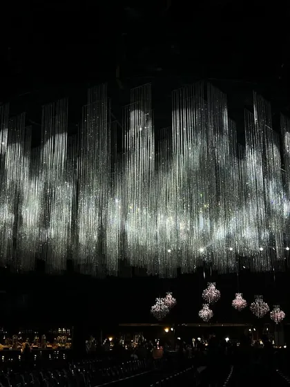 For a grand sangeet night, we created a breathtaking canopy of shimmering crystal tassels. This design shows how we use light and technology to craft an atmosphere of pure, understated elegance.
