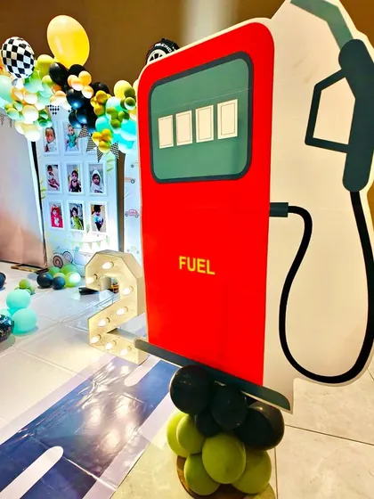 A fun fuel pump prop with a light-up number '2', perfect for a "two fast" car-themed birthday.