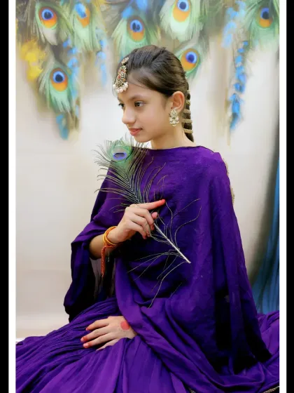 A graceful pose with a peacock feather, this shot from our Radha-themed session captures a sense of elegance and serenity.