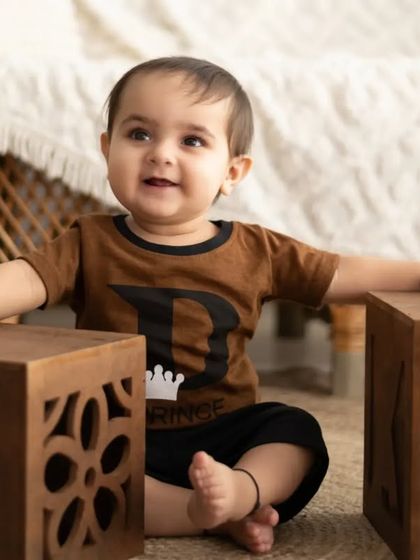 This little prince is taking his first steps with help from mom and dad. We love capturing these important milestones.