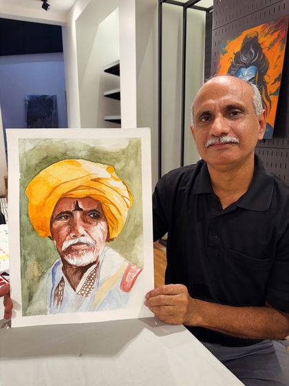 This student is holding up his wonderfully detailed watercolor portrait of a man in a yellow turban, a piece he completed in one of my guided painting sessions.